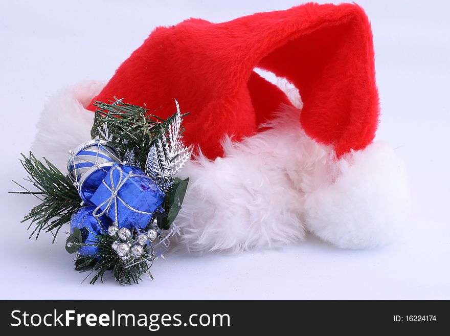 Santa hat and holiday decoration on white.