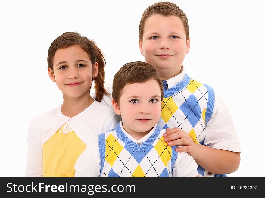 Two brothers and sister in matching outfits over white background. Two brothers and sister in matching outfits over white background.