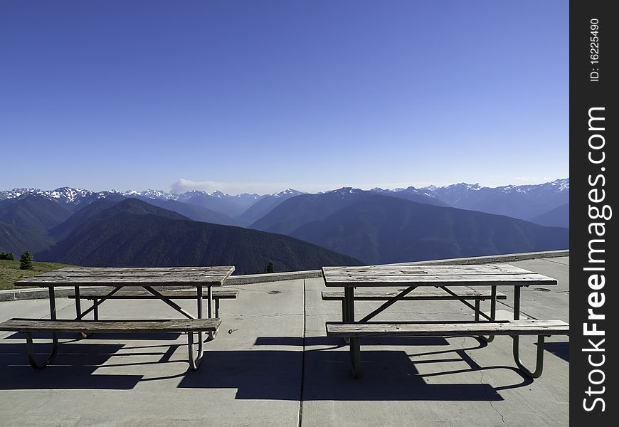 Picnic tables at the mountain summit with view of the range. Picnic tables at the mountain summit with view of the range