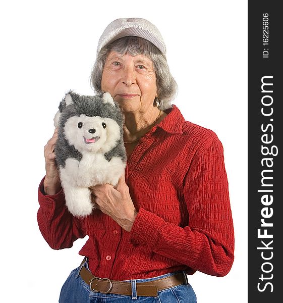 Old senior woman holding stuffed animal. Shot against white background. Old senior woman holding stuffed animal. Shot against white background.