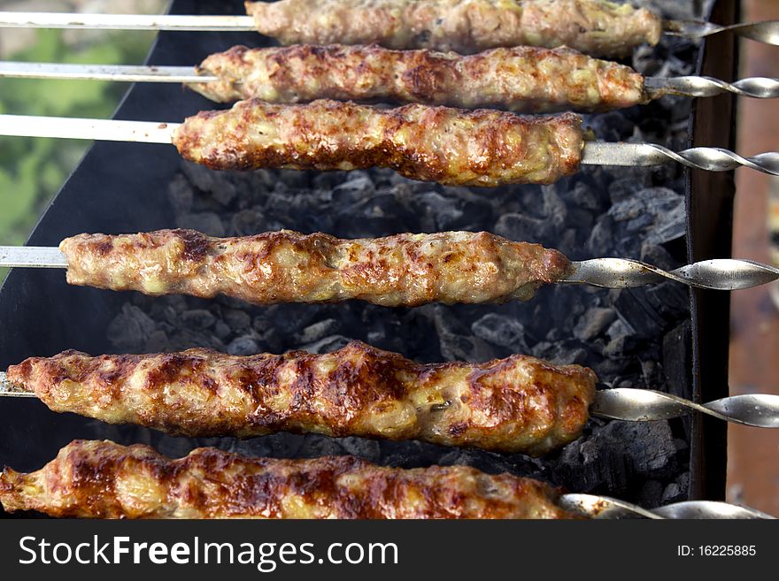Fried shish kebab on a brazier with coals