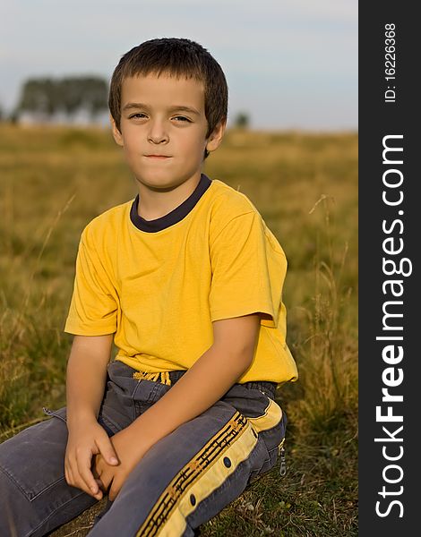 Boy sitting on the grass