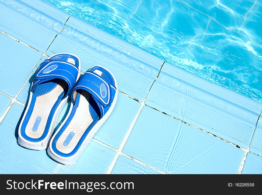 Pretty flip flops by the swimming pool