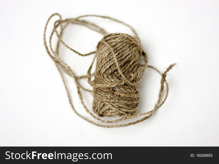 A roll of hemp string on a white background. A roll of hemp string on a white background.