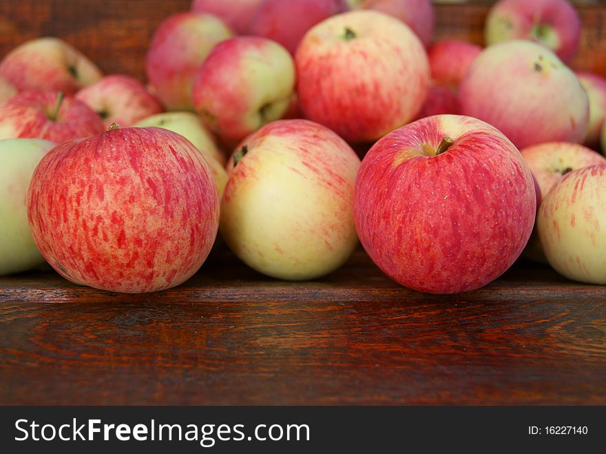 Red apples laying on wooden bench. Red apples laying on wooden bench