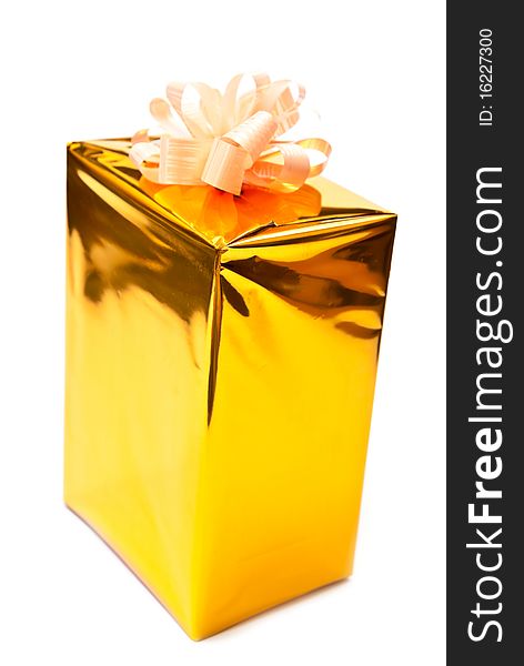 Golden gift box with bow isolated on white. Golden gift box with bow isolated on white