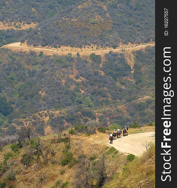 People on horseback along mountain trails. People on horseback along mountain trails