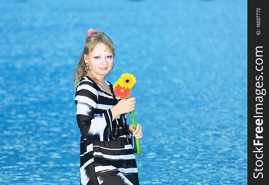 Beautiful woman with flowers in the sea. Beautiful woman with flowers in the sea