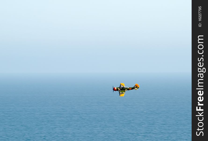 World war two aircraft flying across the blue horizon and blue sea. World war two aircraft flying across the blue horizon and blue sea.