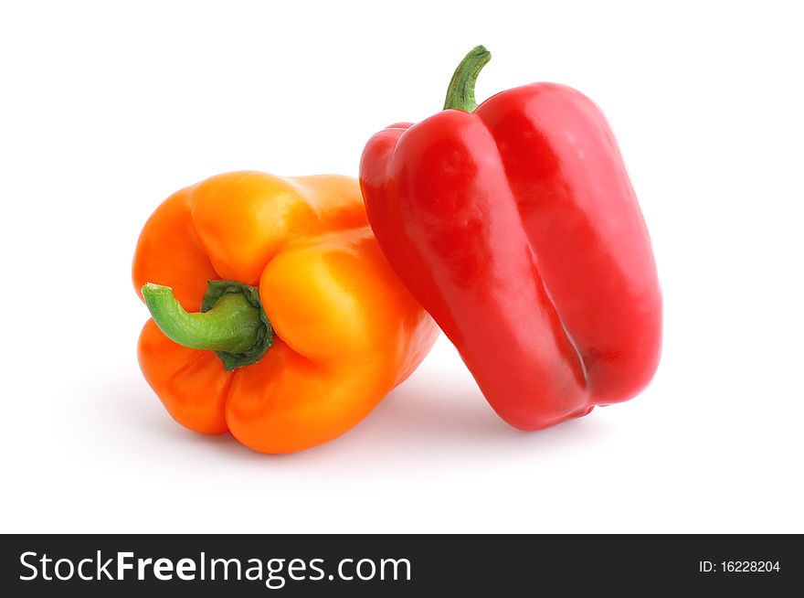 Red and orange bell peppers isolated on white with soft shadow