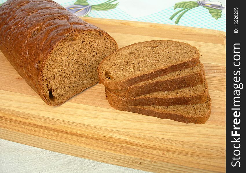 Loaf of rye bread, sliced into pieces, is shown in the image. Loaf of rye bread, sliced into pieces, is shown in the image.