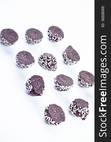 Small candy-coated chocolate cream over white