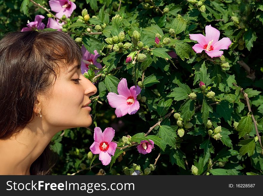 Young Attractive Girl Enjoying Flowers