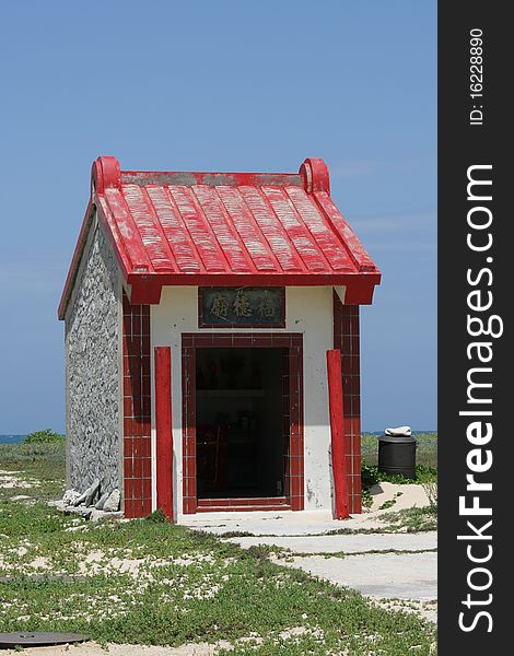 This small red and white house is in fact a Chinese shrine. This small red and white house is in fact a Chinese shrine