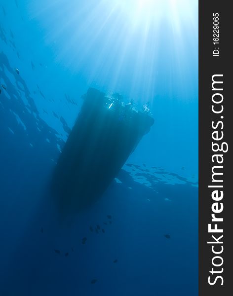 Underwater view of boat silhouette with sunrays. Temple, Sharm el Sheikh, Red Sea, Egypt.