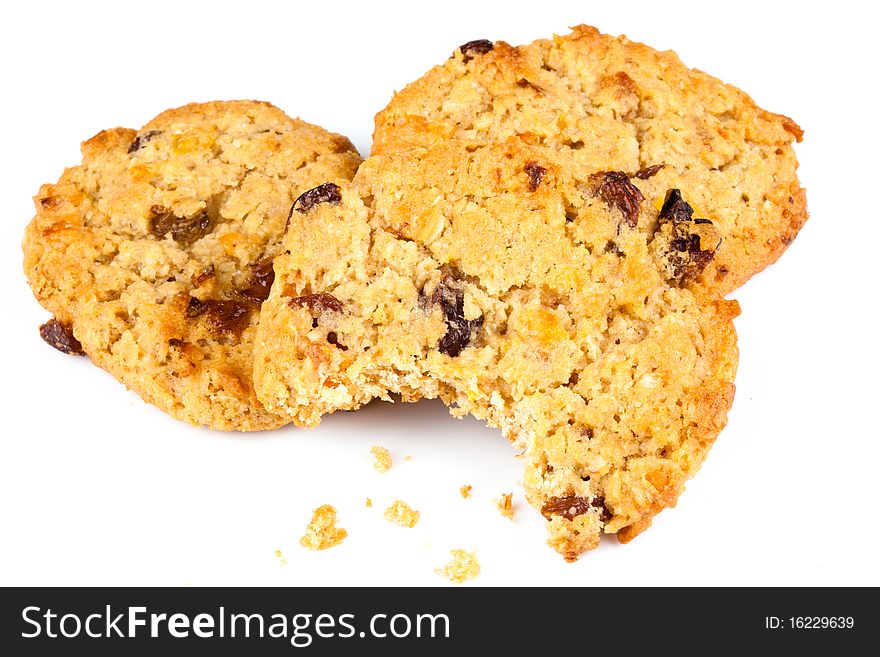 Three oat and raisen cookies with on with a bite taken out of it. Three oat and raisen cookies with on with a bite taken out of it