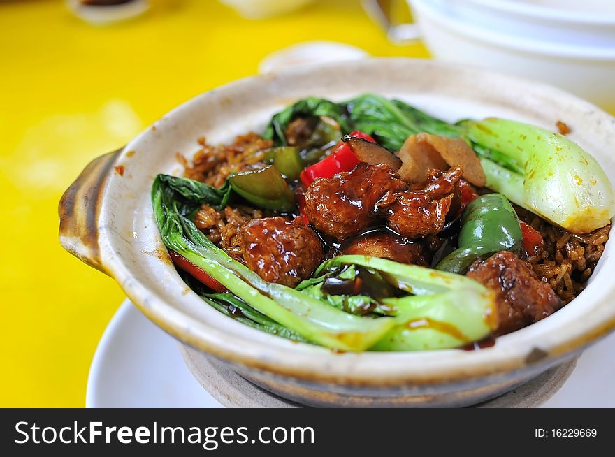 Vegetarian oriental sweet and sour pork dish prepared in traditional claypot. Suitable for food and beverage, healthy lifestyle, and creative food. Vegetarian oriental sweet and sour pork dish prepared in traditional claypot. Suitable for food and beverage, healthy lifestyle, and creative food.