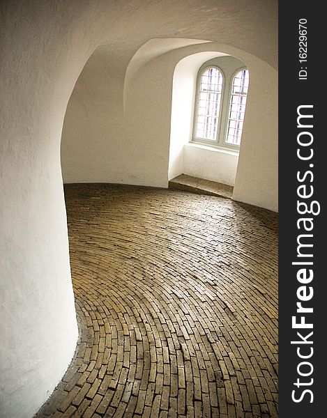 Historical spiral hallway with brick floor