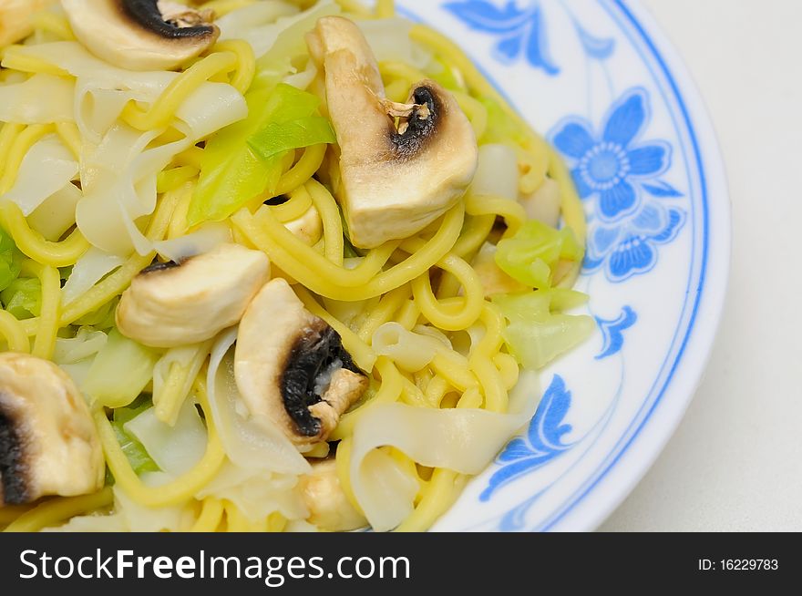 Asian style vegetarian noodles cooked with vegetables and mushrooms.