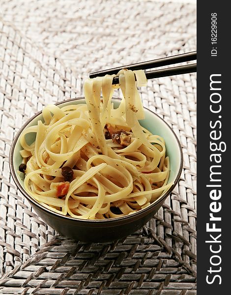 A delicious tasty oriental noodles with chopsticks dinner. A delicious tasty oriental noodles with chopsticks dinner