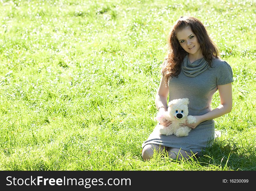 Girl Sitting On Green Grass