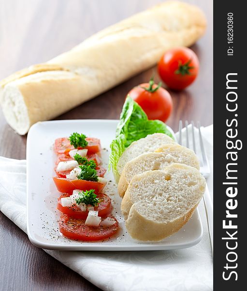 Tomato salad with onion and baguette