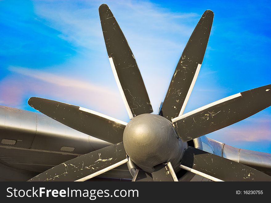 Plane Motor with Propeller and air intake against blue sky