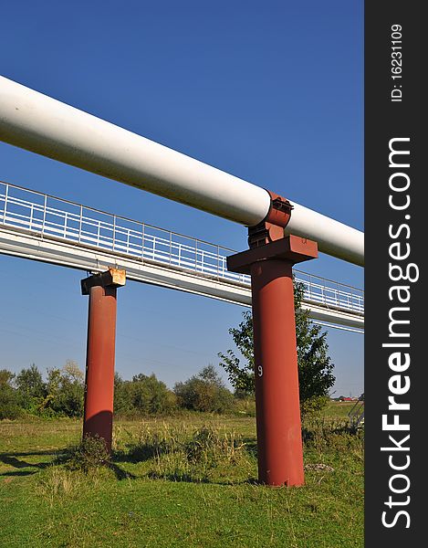 High pressure pipelines in a summer landscape with the dark blue sky. High pressure pipelines in a summer landscape with the dark blue sky