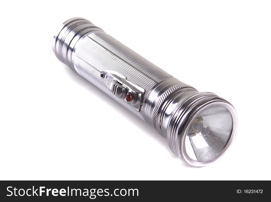 An antique flashlight isolated on a white background. An antique flashlight isolated on a white background.