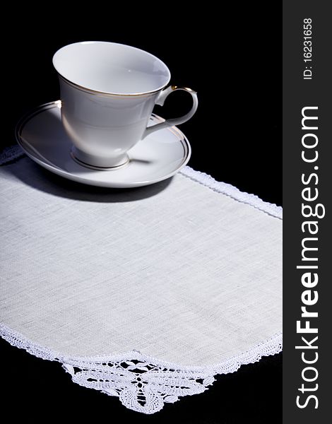 Cup on white doily with lace