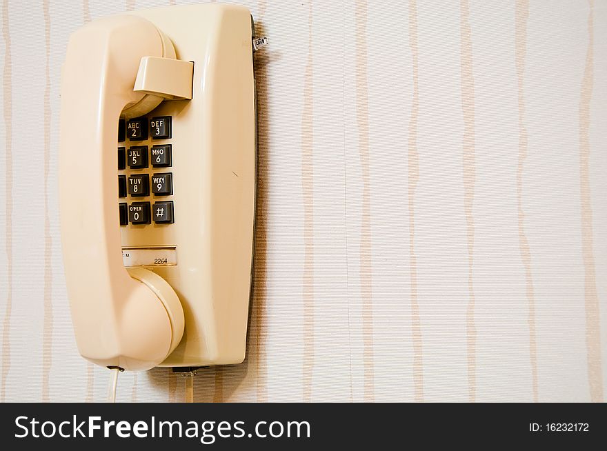 Retro style press-button telephone mounted on a wall. Retro style press-button telephone mounted on a wall.