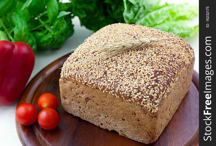 Fresh brown bread on wooden board