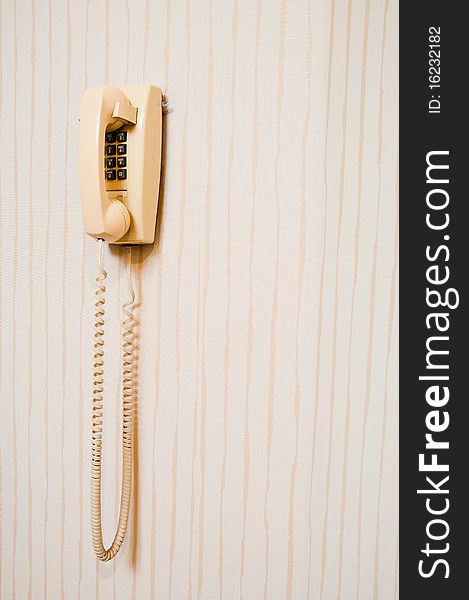 Retro style press-button telephone mounted on a wall. Retro style press-button telephone mounted on a wall.