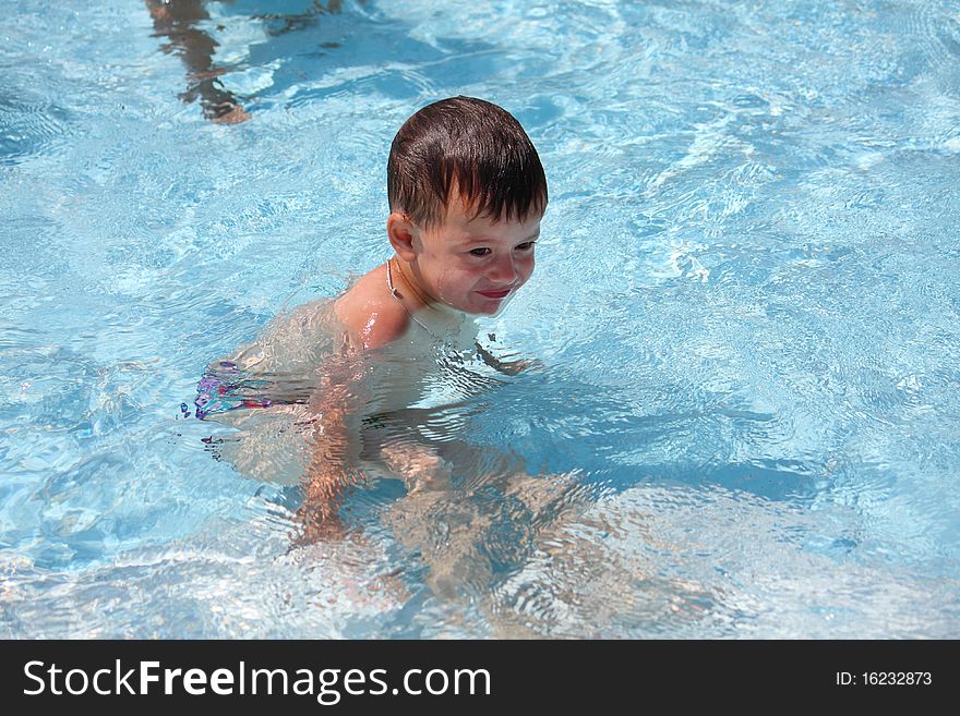 The little boy bathes in pool. The little boy bathes in pool