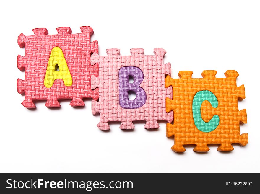 The alphabet puzzle from colorful plastic blocks