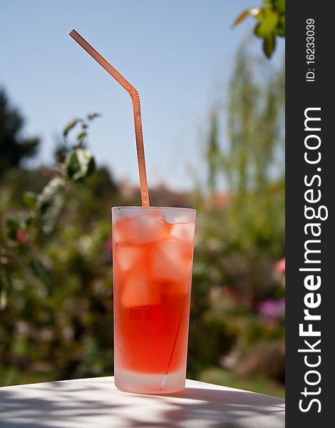 Cocktail with ices and drinking straw