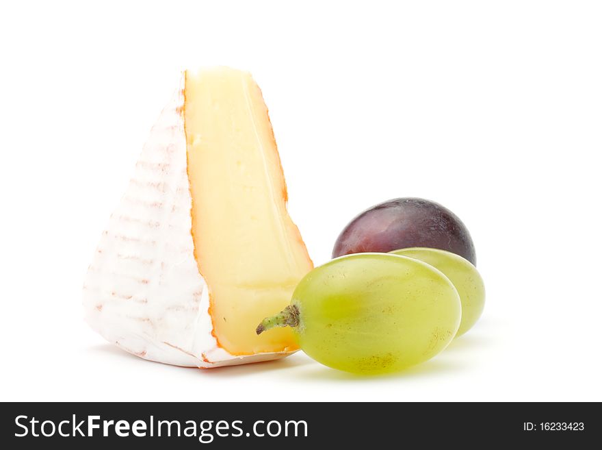 Piece of soft cheese and grapes. Isolated on a white background. Piece of soft cheese and grapes. Isolated on a white background.