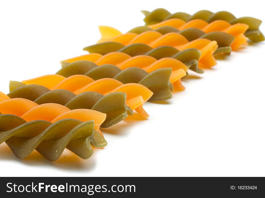 Uploaded some pasta - fusilli. Close-up. Two colors that alternate: green, red. Isolated on white background. Uploaded some pasta - fusilli. Close-up. Two colors that alternate: green, red. Isolated on white background.