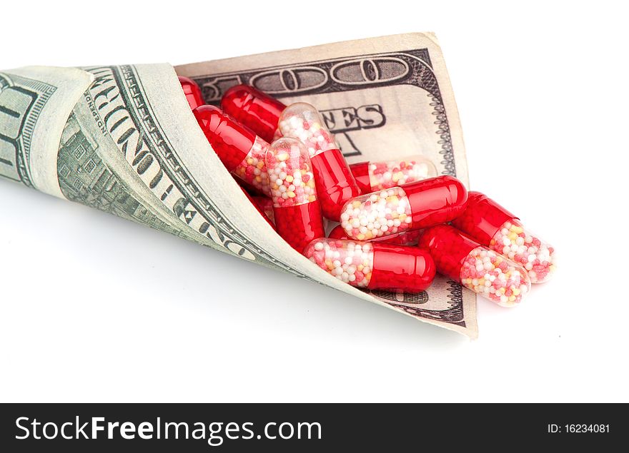 Money and pills isolated on a white