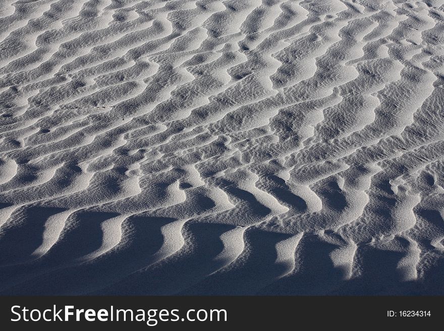 Texture of white sand dunes for background