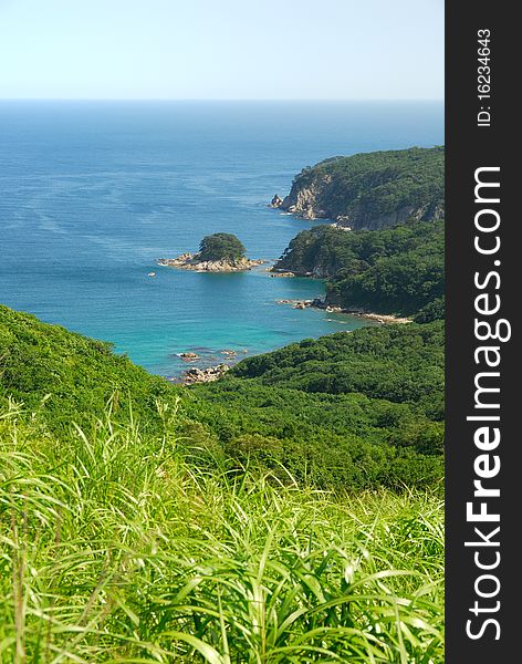 Summer ocean bay view with small islet and calm water. Summer ocean bay view with small islet and calm water