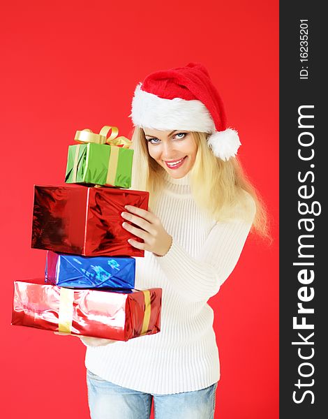 Santa girl with presents on red background