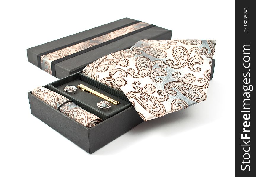 Tie with cufflinks in a box on a white background