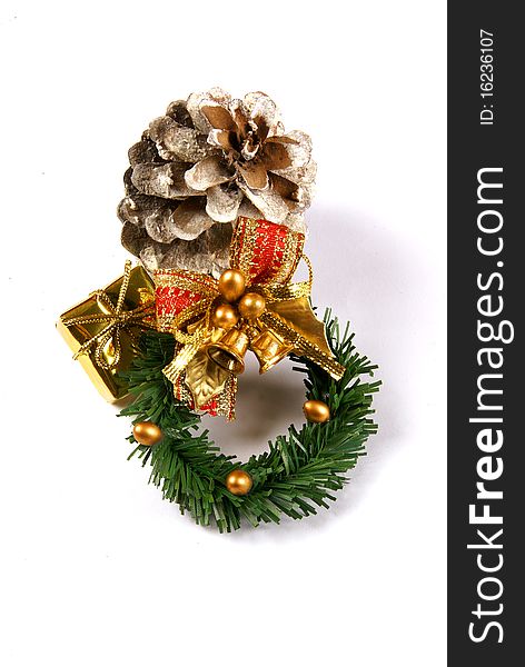 Christmas wreath with a gold present and frosted pine cone isolated on a white background. Christmas wreath with a gold present and frosted pine cone isolated on a white background