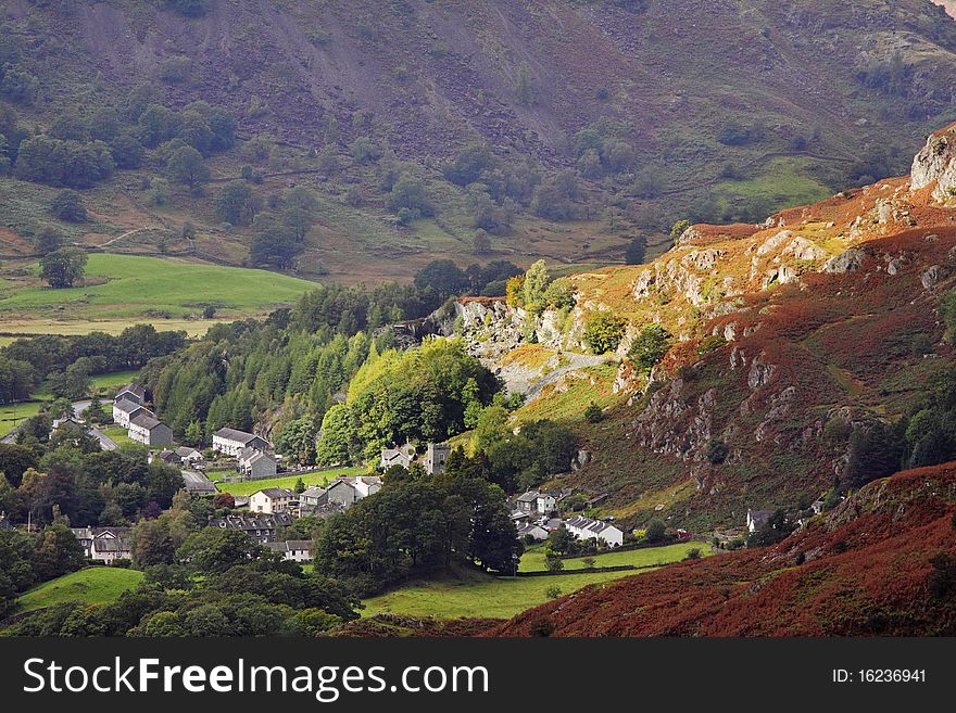 A Mountainside Village in the English Lake District with Sunshine lighting it up. A Mountainside Village in the English Lake District with Sunshine lighting it up