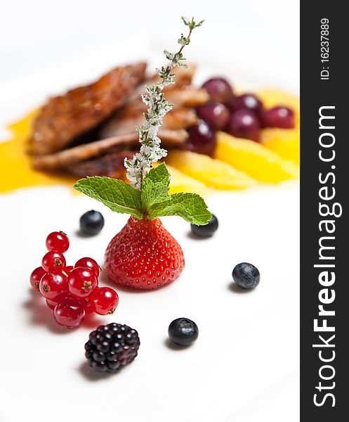Berries with roasted duck breast fillet on background
