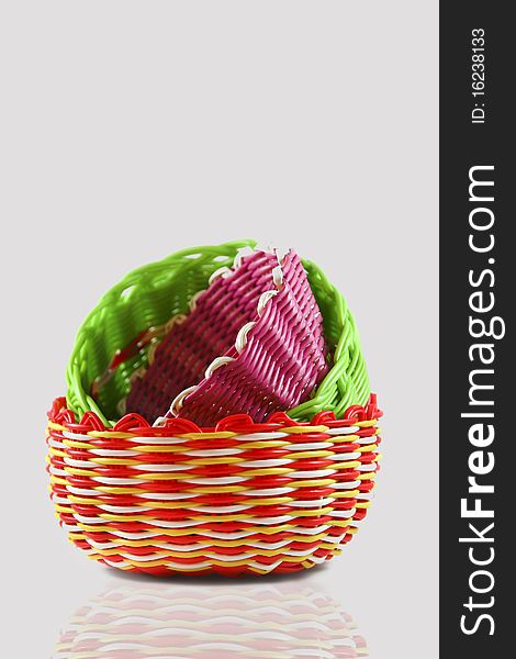 Colorful woven basket isolated on a white background