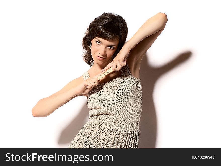 Portrait of young beautiful woman with fan. White background. Studio shot.