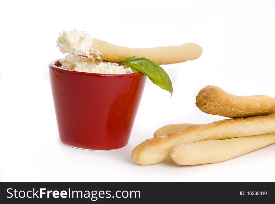 Cream cheese and bread sticks isolated on white background