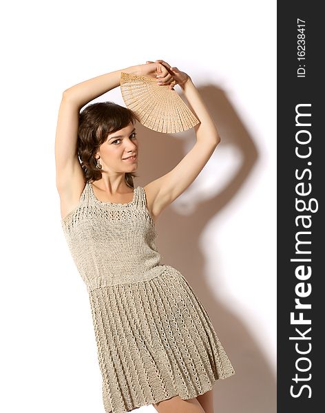 Portrait of a young woman with fan. White background. Studio shot.